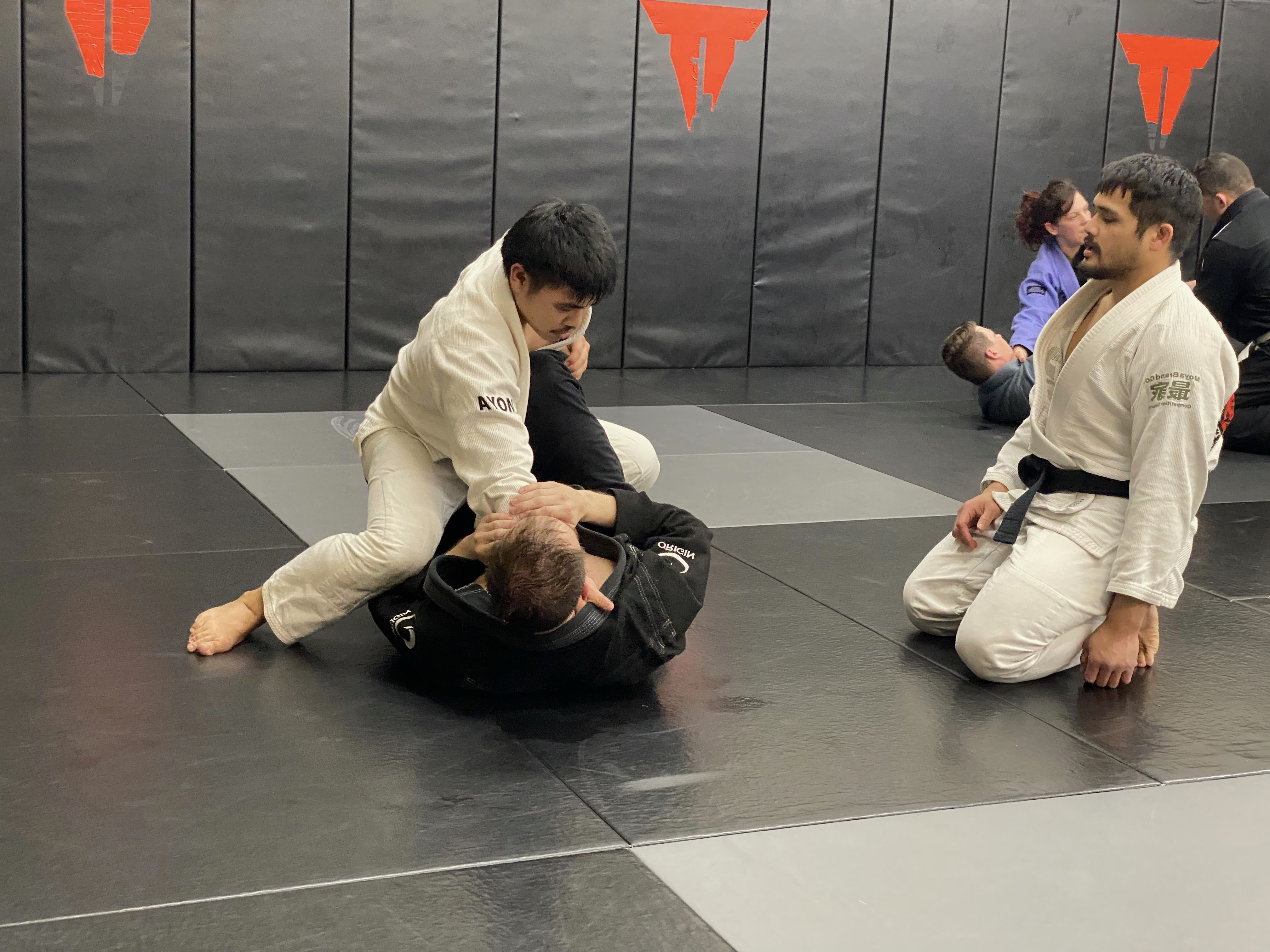 Instructor Tim coaching two students through a technique